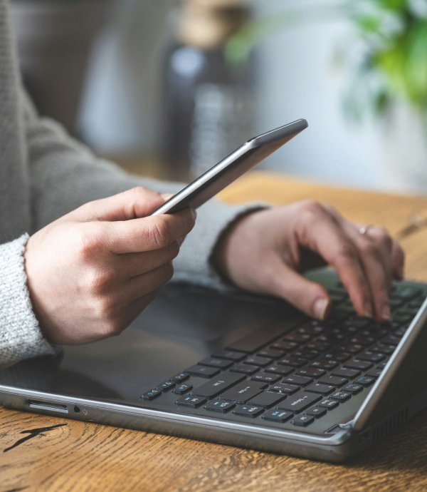 organic social media strategies - computer and phone being used.